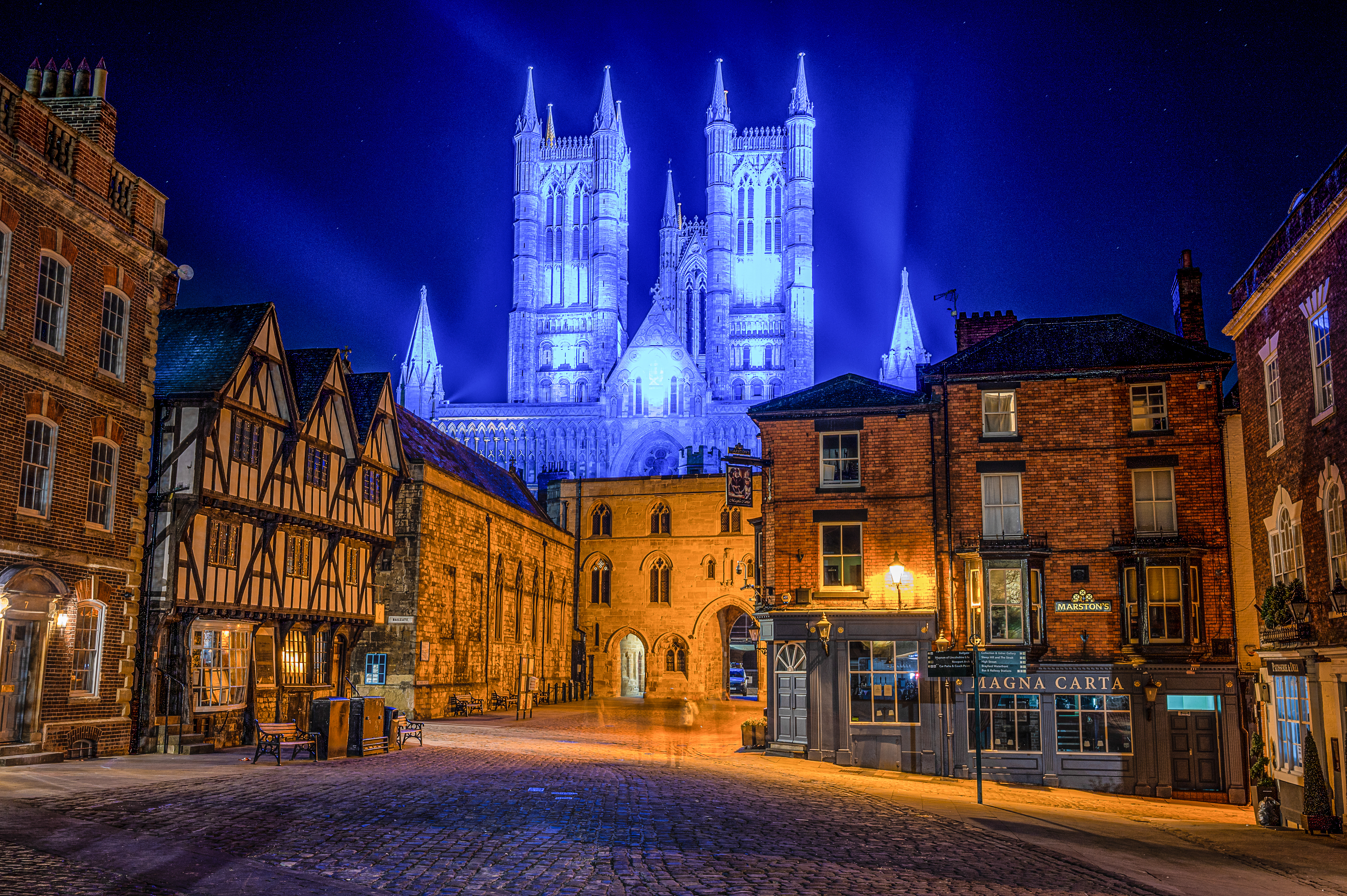 Lincoln Cathedral lit up in blue in the evening