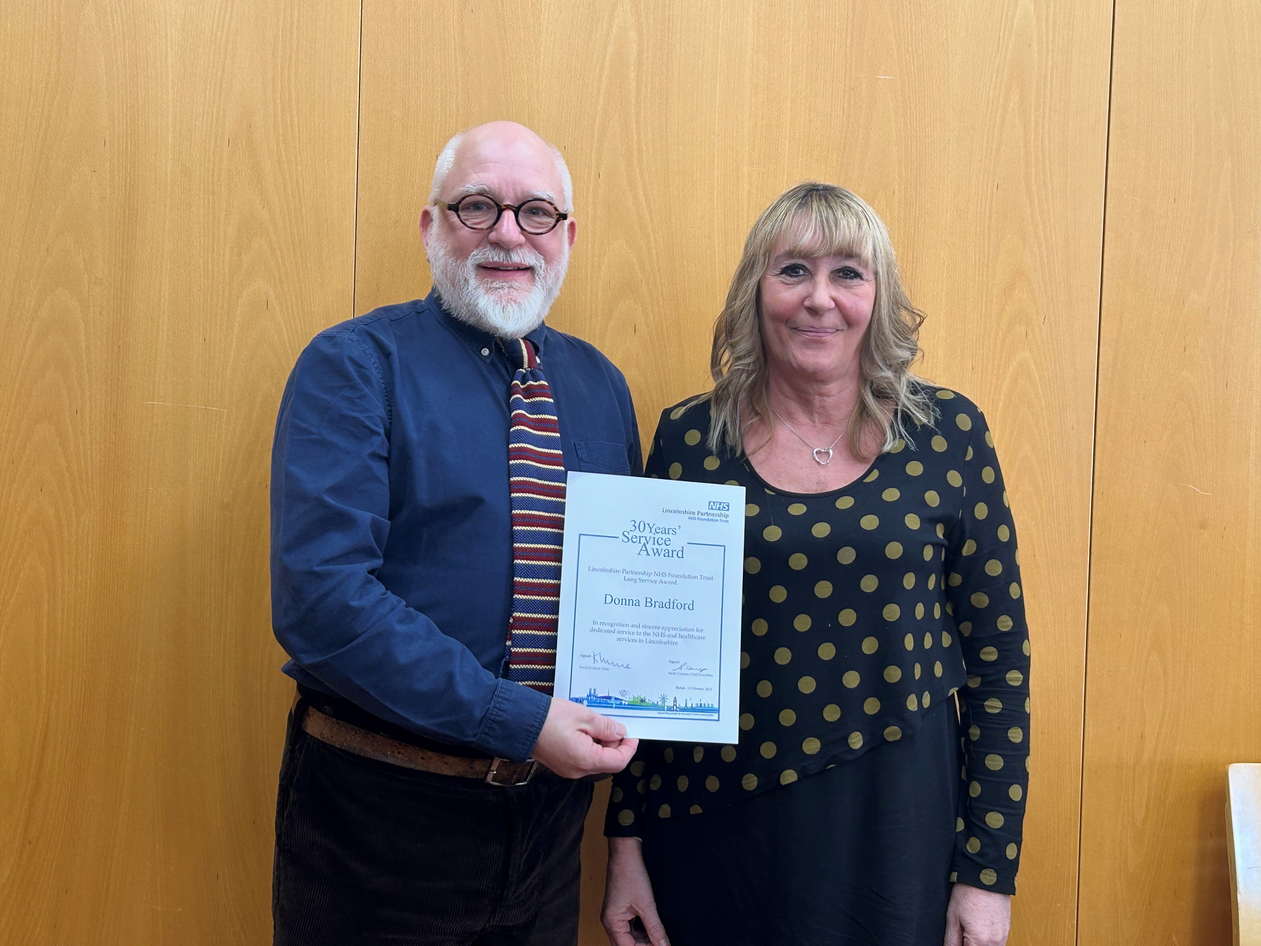 Left, Kevin Lockyer; right, Donna Bradford with her Long Service Award