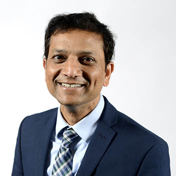 Girish Kunigiri smiling at the camera.