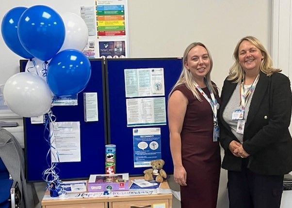 Two members of the RECONNECT team with balloons